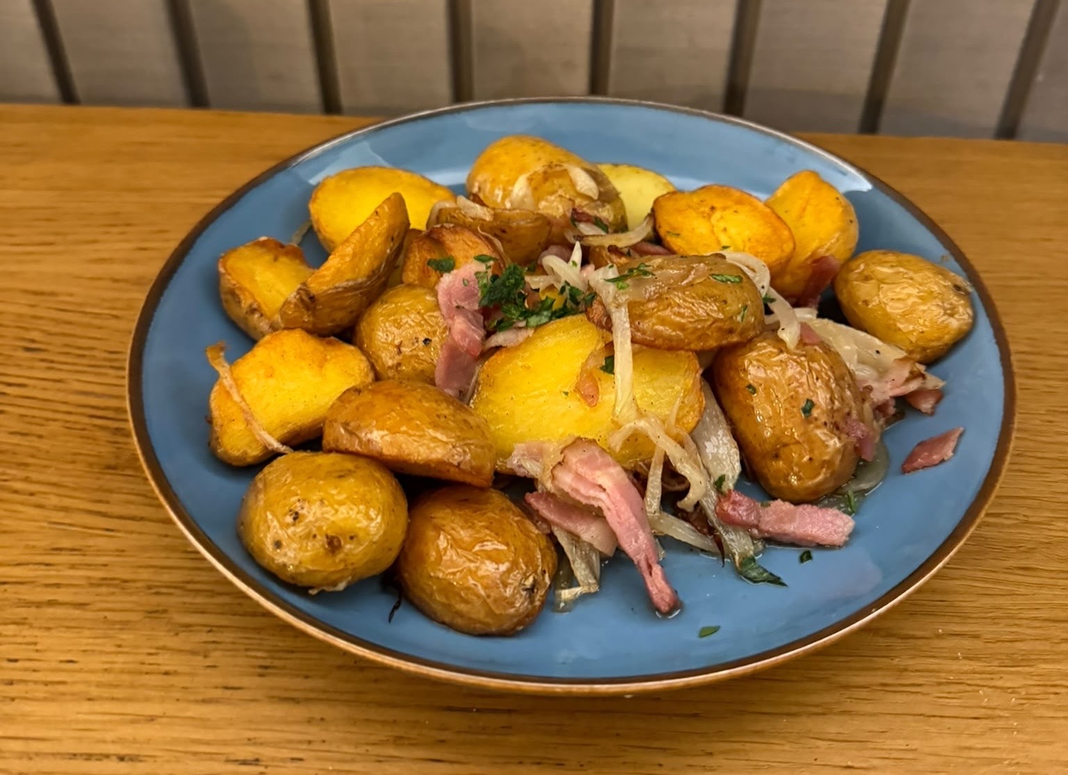 Roasted potatoes on bacon with onions